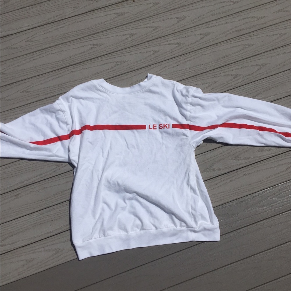 White shirt with red stripe.